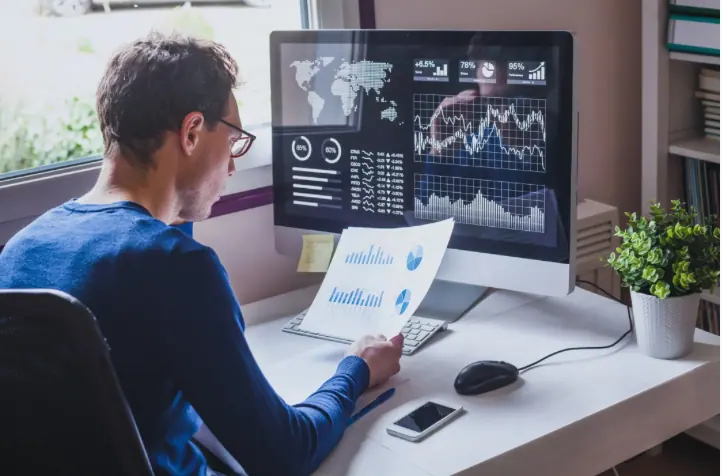 An analyst reviewing financial charts and performance data
