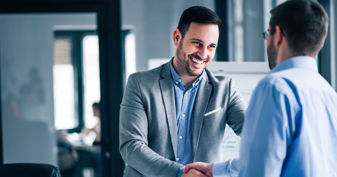 Two business professionals meeting and shaking hands