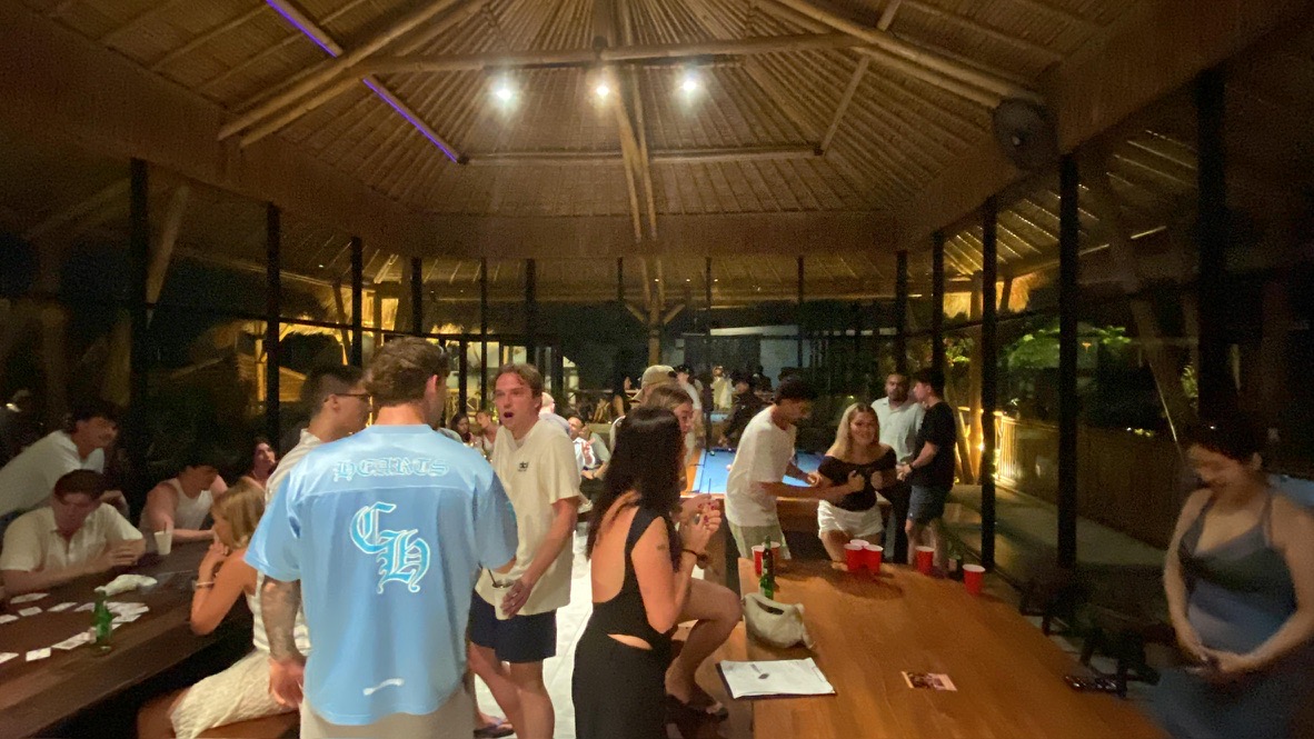 Interns playing games and talking at a villa in the evening