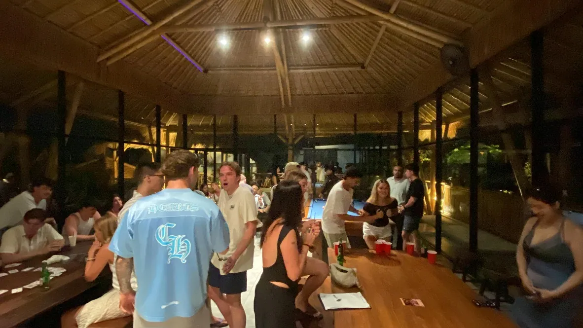 Interns playing games and talking at a villa in the evening
