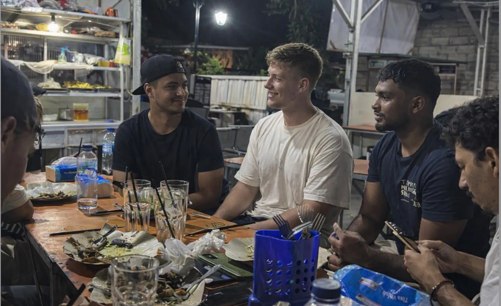 Island Internship students and team eating together at a warung in the evening
