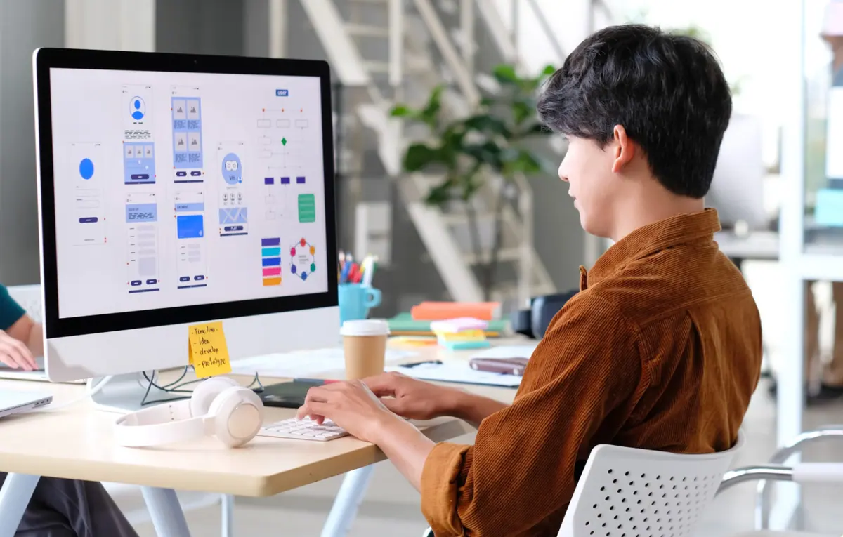 A designer reviewing animated app screens on a monitor