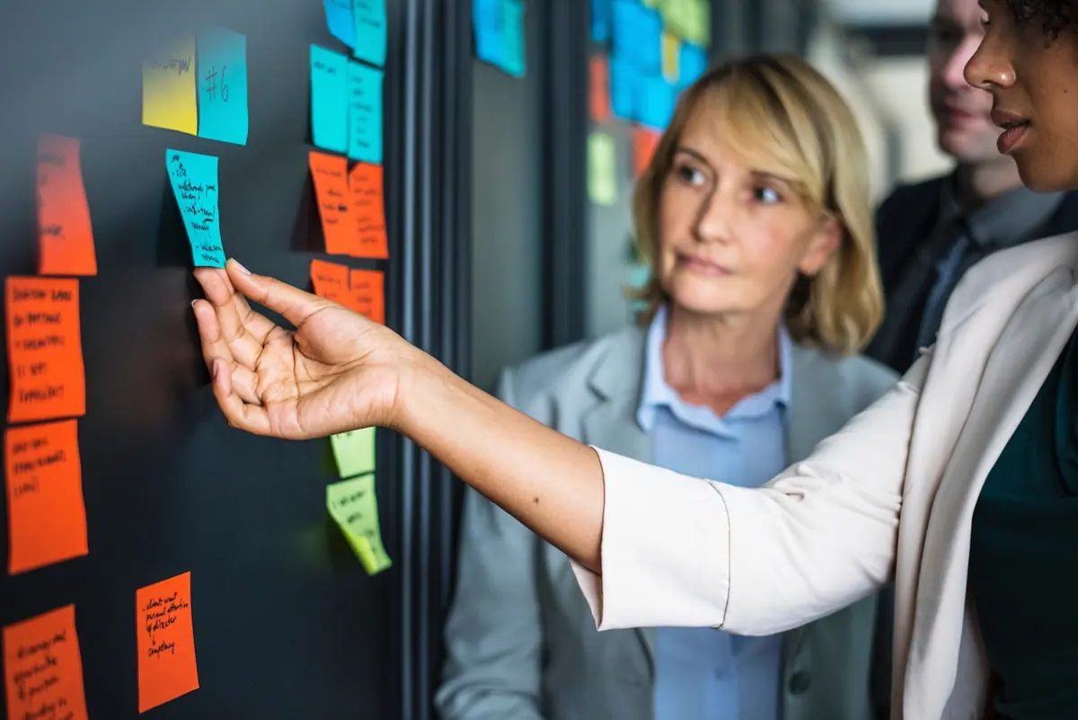 A product team planning work around a wall of notes