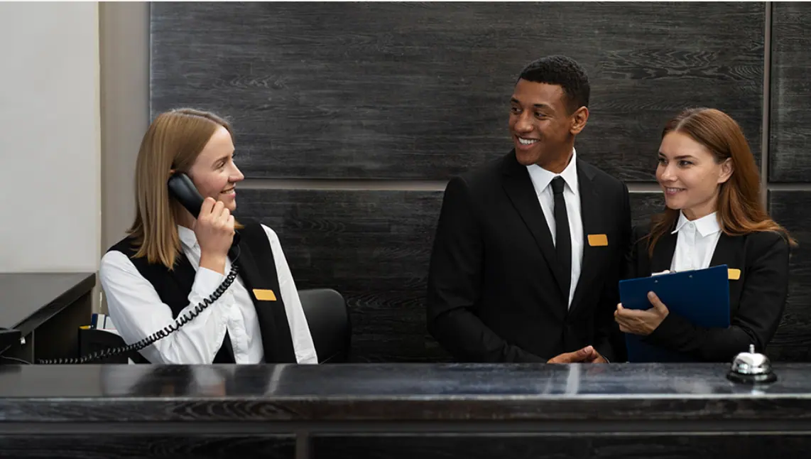 Hotel team welcoming guests at reception