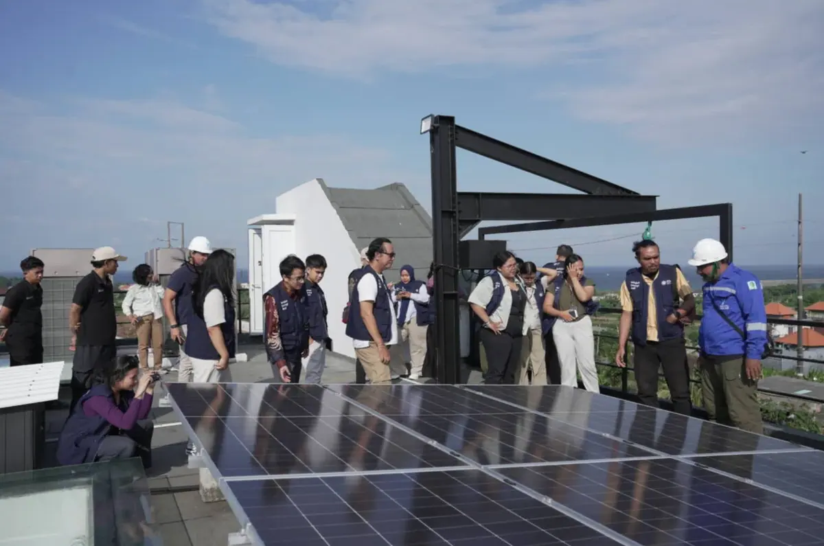 Team reviewing solar panels at a renewable energy installation