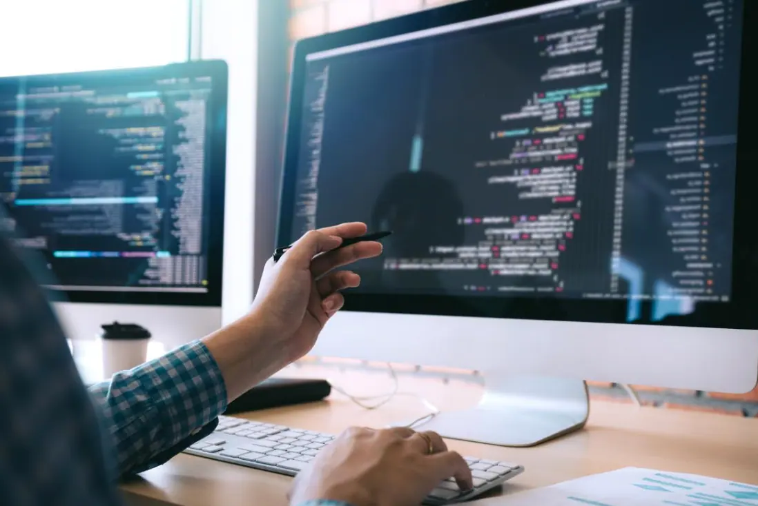 A developer reviewing code on a large display